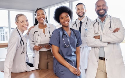 5 médecins dans un établissement médical, expliquant comment faire valoir ses acquis grâce à la VAE  